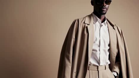 stylish man posing in different outfits with sunglasses