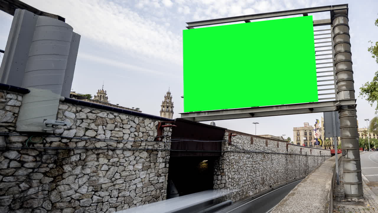 Rush of traffic on highway in city with green screen on the overhead video
