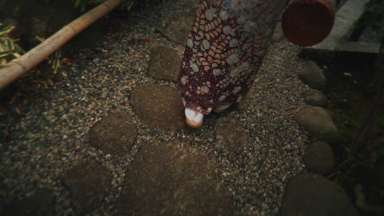 Person in Kimono Walking on Garden Path