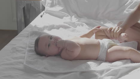 cute happy baby laying in bed