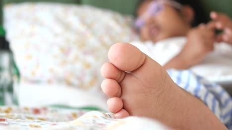 child's foot on a bed