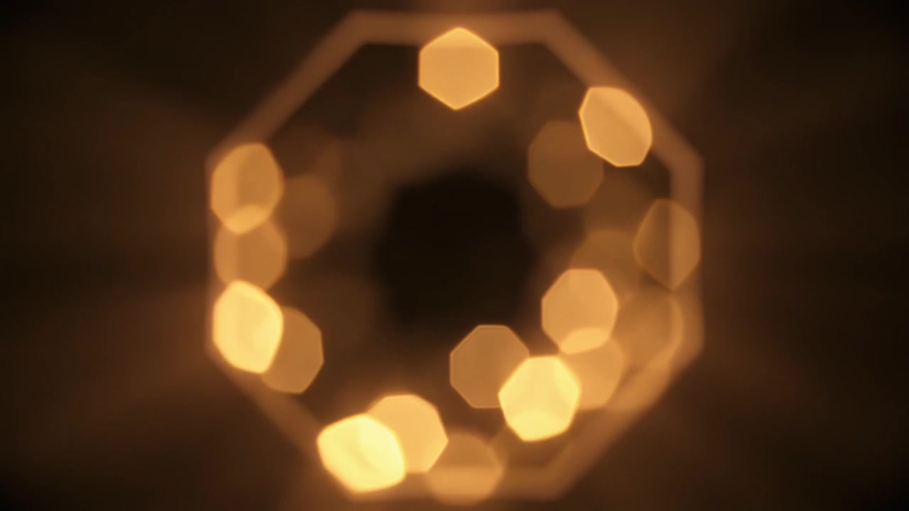Luci bokeh dorate astratte che formano una forma ottagonale