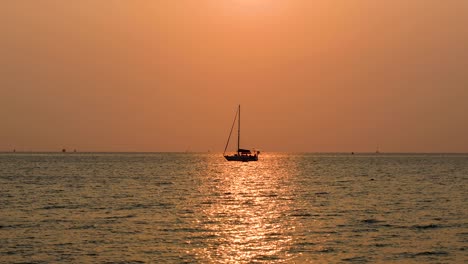 amazing sunset in thailand with a yacht on the horizon with pink and orange skies in bangsaray near pattaya