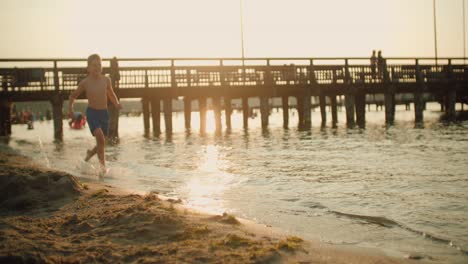 kid running on the beach slow motion