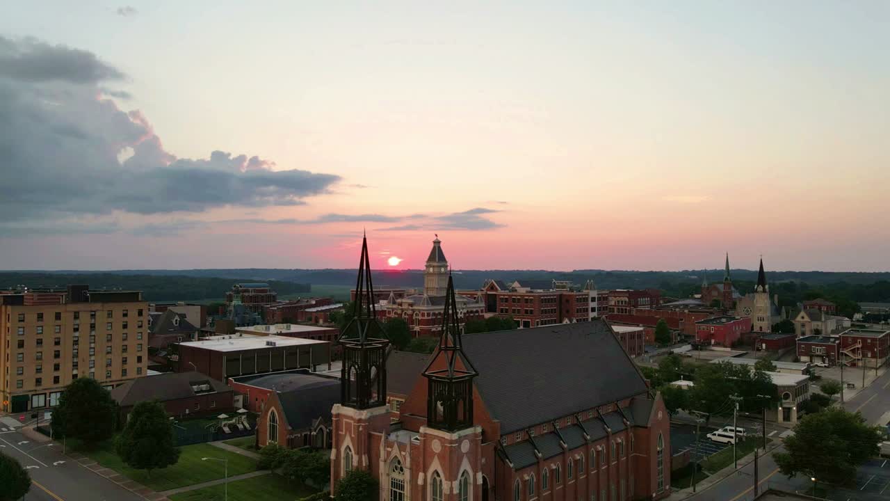Drone rising up over a church, revealing the sunset in Clarksville Tennessee