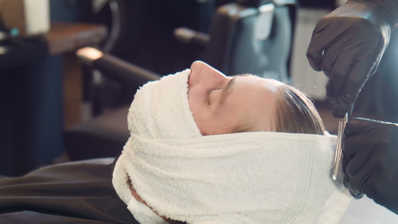 Man getting a haircut and shave at the barbershop