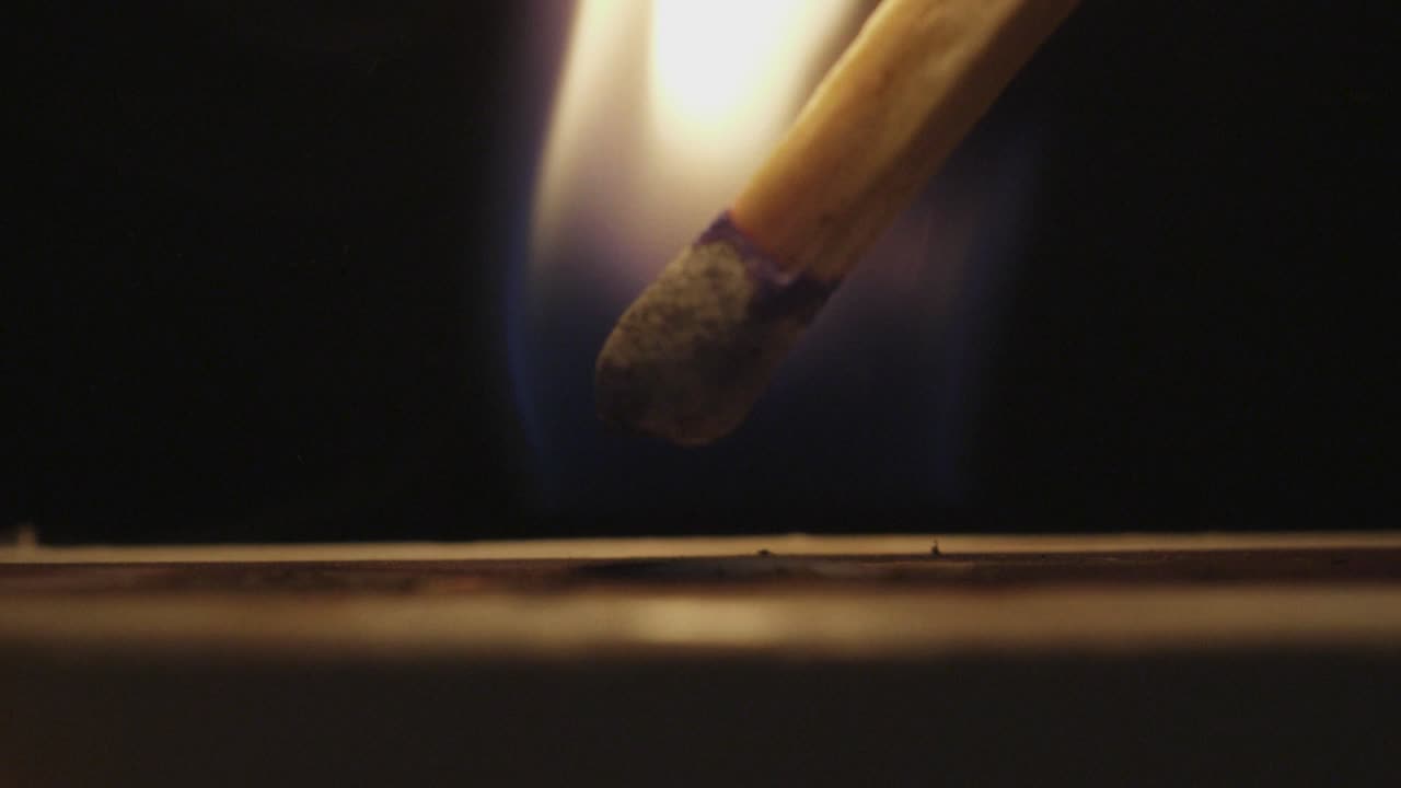 Fire matchstick. Ignition of match with smoke, isolated on black background. Slowmotion.Scene B.