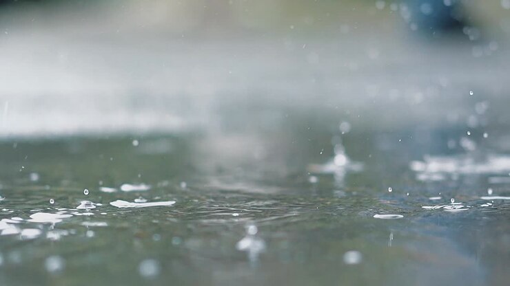 It is raining outside Rain drops break in a puddle 1