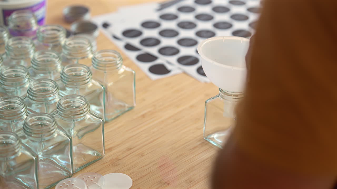 Man Organizing And Transferring Dried Chives On Spices New Jars. - closeup shot