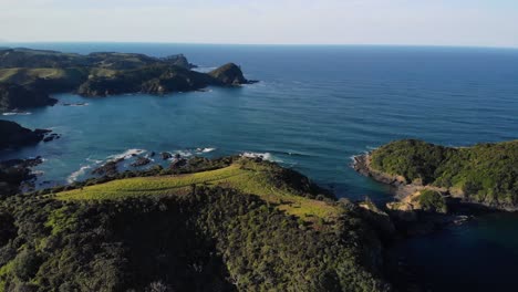Panoramic-View-Of-Tutukaka-Coast-In-Northland,-New-Zealand-During-Golden-Hour---aerial-pullback