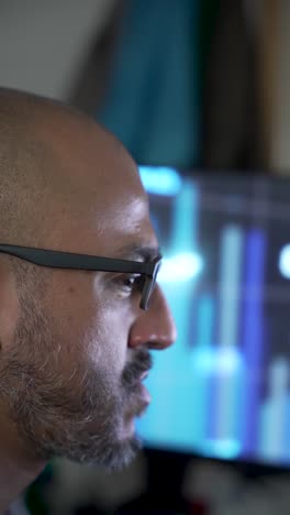 focused individual observing financial trends on a screen with analytic graphs. vertical video