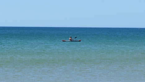 Man-Kayaking-at-Sea,-Sunny-Day.-Tracking-Shot