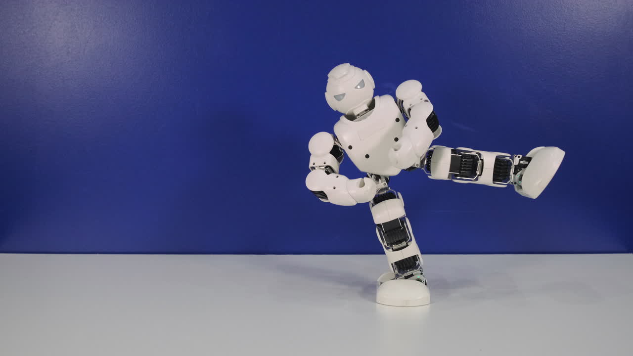 White Robot Toy Posing and Kicking