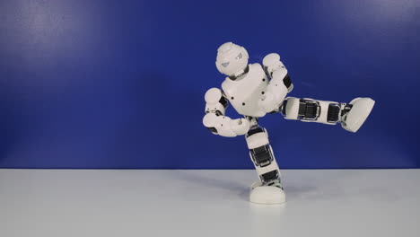 white robot toy posing and kicking