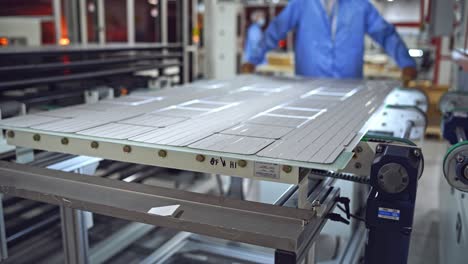 producing process of solar panel. automated technology of producing solar cells. ready solar panel on the board on a modern factory background.
