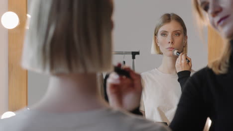 mua preparing female model for photoshoot