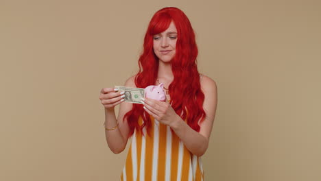 poor girl upset over insufficient amount of money, holding piggybank, one dollar banknote bankruptcy