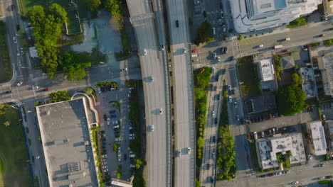 Top-down-panning-footage-of-transport-infrastructure-in-city.-Vehicles-driving-on-busy-multilane-highway-and-using-exit-ramps.-Miami,-USA
