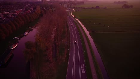 drone shot of highway at the golden hour by the green pasture in amsterdam