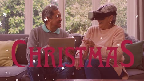 animation of christmas text over biracial couple using vr headset
