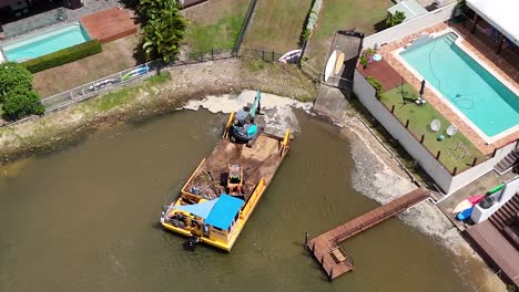 drone captures barge and crane in urban canal