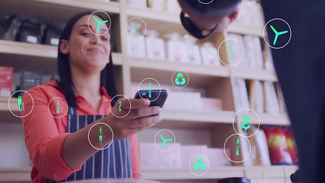 animación de iconos y procesamiento de datos sobre mujer biracial con terminal de pago en una cafetería