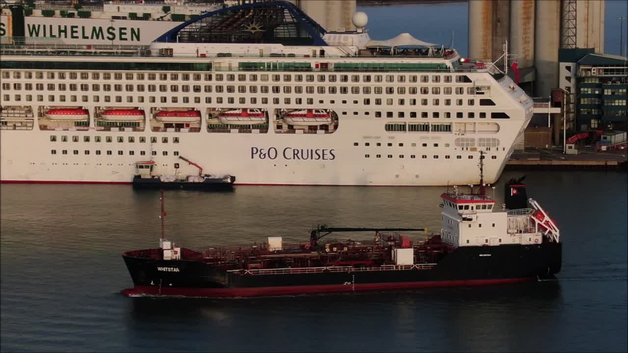 Large refulling ship passing cruise shps. Southampton cruise terminal.