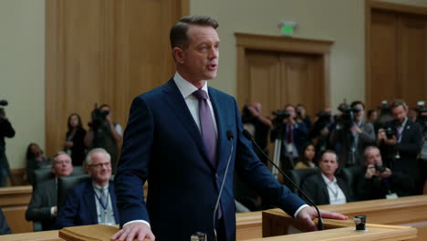 a man delivers a speech at a podium during a formal event