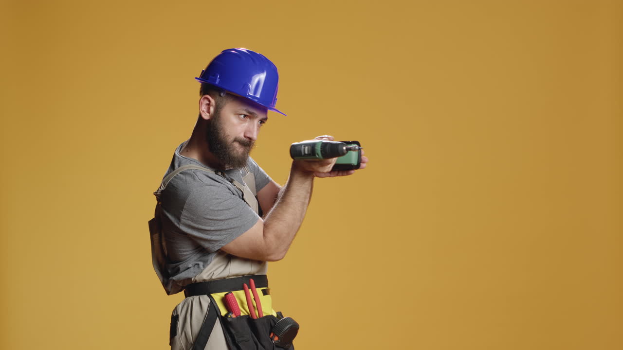 Portrait of repairman builder using electric power drill machine