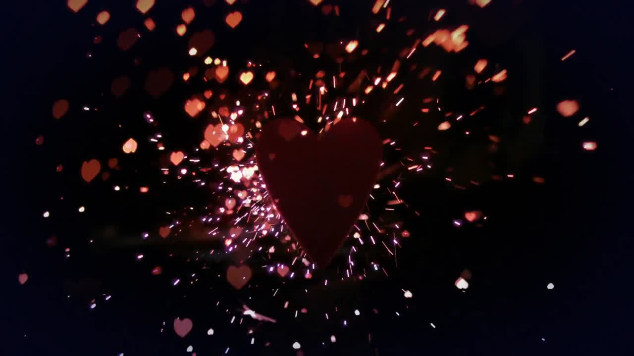 animación de corazones rojos y brillo cayendo sobre un fondo negro
