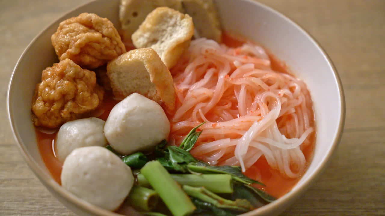 small flat rice noodles with fish balls and shrimp balls in pink soup, Yen Ta Four or Yen Ta Fo - Asian food style