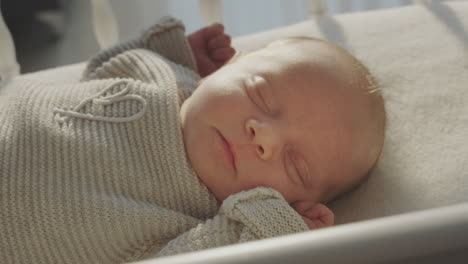 sleeping newborn baby in a crib