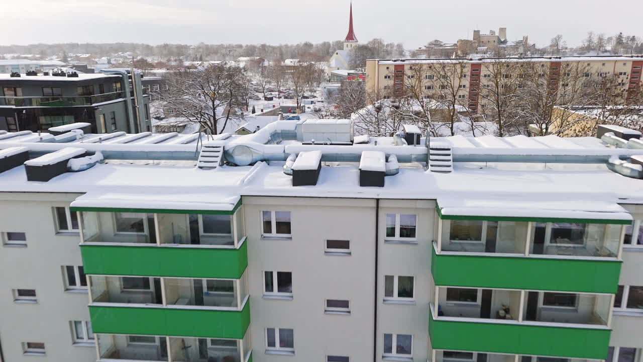 Aerial view over snowy condos, toward the church, winter in Rakvere, Estonia