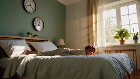 happy woman in pajamas enjoying morning in bedroom