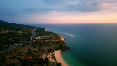 4K-Cinematic-nature-drone-footage-of-a-panoramic-aerial-view-of-the-beautiful-beaches-and-mountains-on-the-island-of-Koh-Lanta-in-Krabi,-South-Thailand,-during-sunset