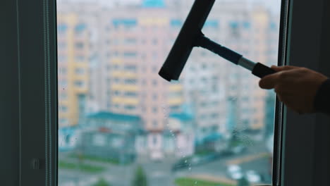 professional cleaning window indoor. man cleaning window with special equipment.