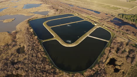 water purification basin, recycling water along a swamp vendres france aerial