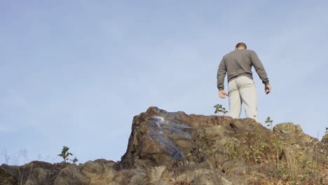 man standing on top of a rocky mountain