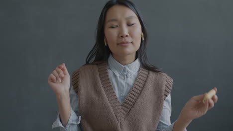 Woman looking thoughtfully while holding something