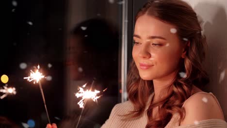 Happy-Young-Woman-Dancing-with-Sparklers.Happy-young-woman-dancing-with-sparklers-near-snowy-pine-trees