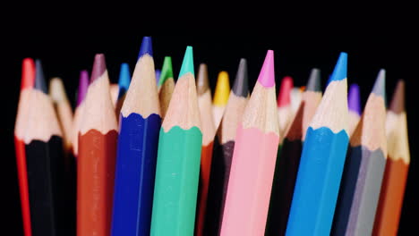 A-Set-Of-Multi-Colored-Pencils-On-A-Black-Background