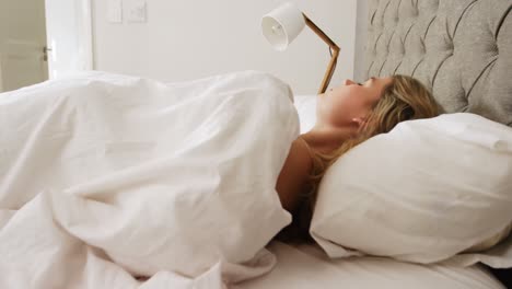 Young-woman-sleeping-on-her-bed