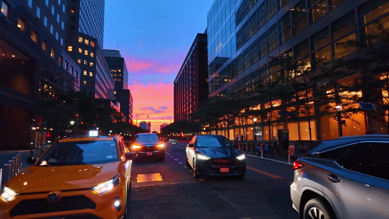 New York, USA, 5 June 2026 : Rush hour taxis at sunset, Lower Manhattan, New York. Frontal road view features orange cabs, lane markings, office facades and a blue sky.