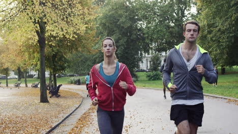 athletic couple running in park wearing wearable technology connected devices