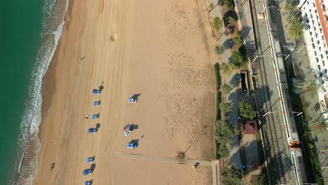 Aerial-views-of-the-Rodalies-train-with-the-sea-in-the-background-in-the-province-of-Barcelona