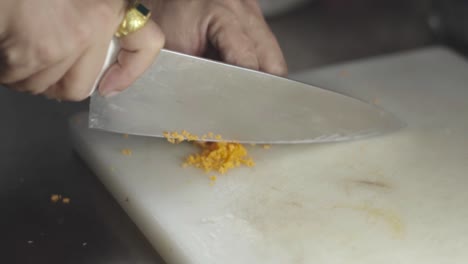 chef cutting carrot closeup view