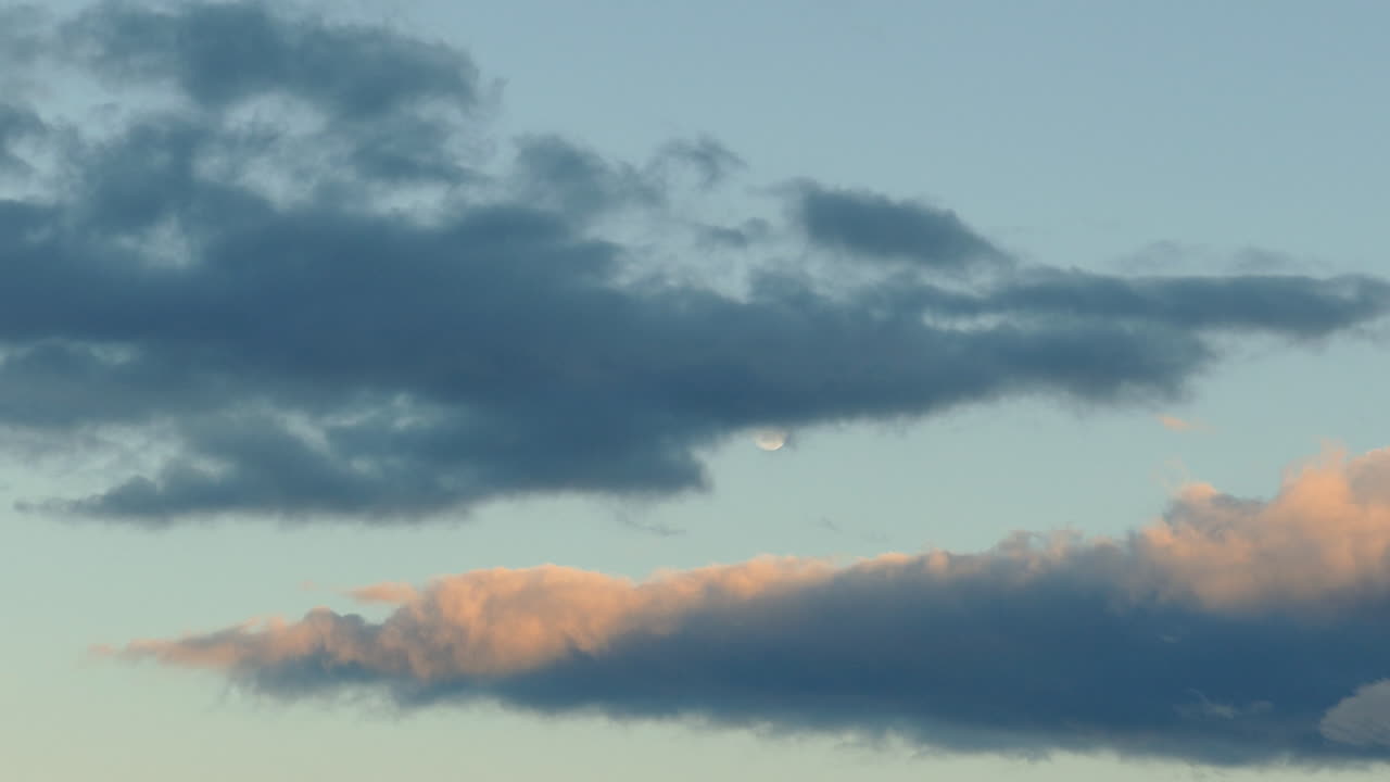 Beautiful time-lapse of clouds and the moon at sunset in California