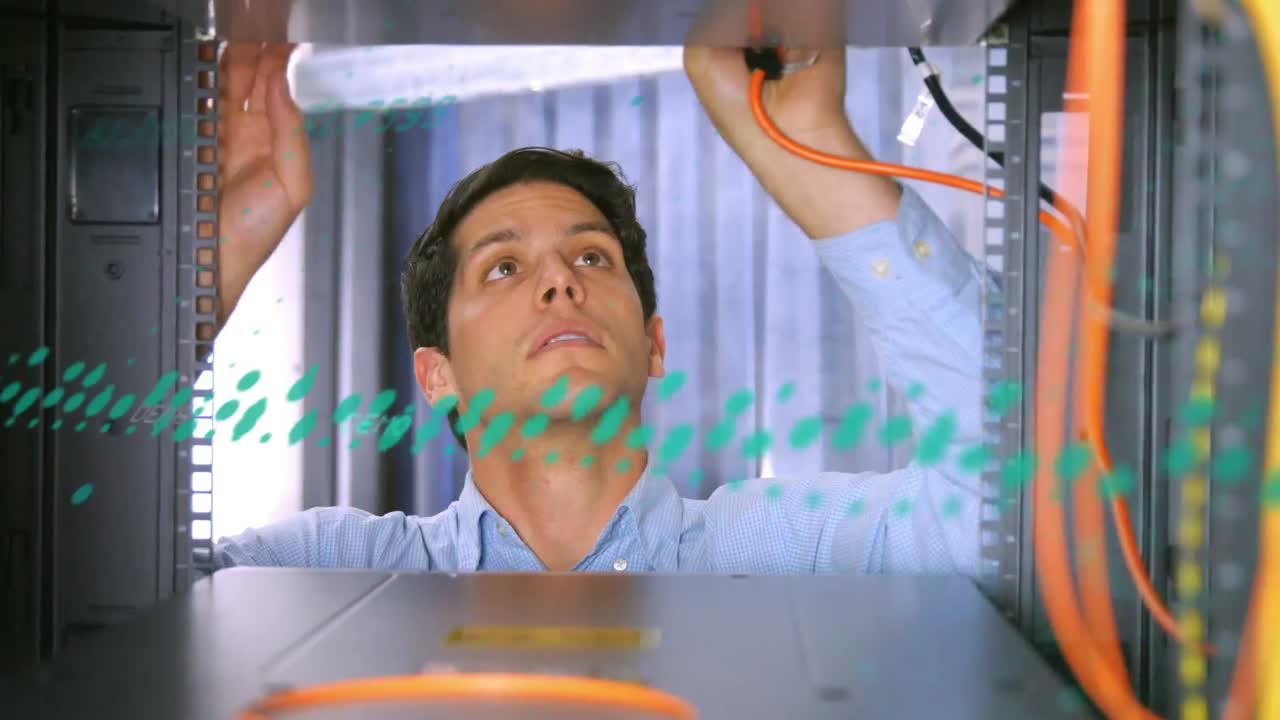 Animation of spots over caucasian businessman in server room