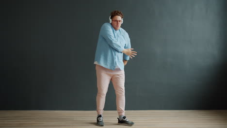 man dancing to music with headphones