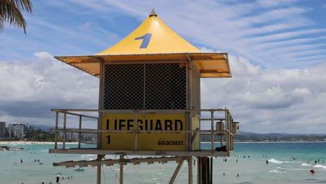 sunny day at a crowded beach with lifeguard station